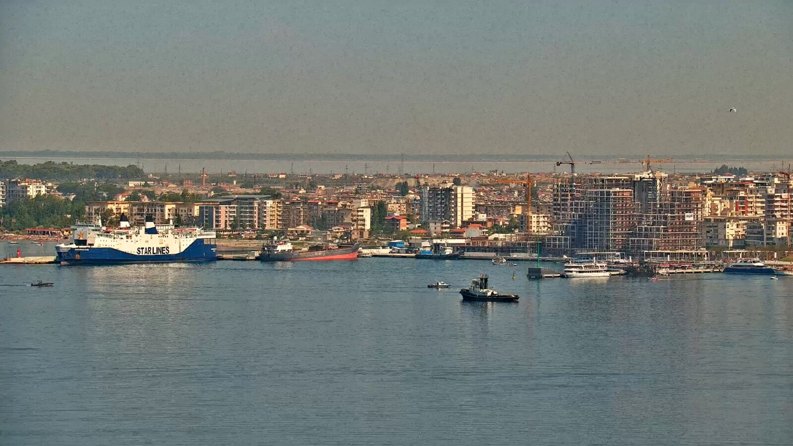 Ferry, working boats and harbour activity in Vlora Bay